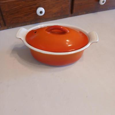 Vintage Le Creuset heritage-style Decoware mini dutch oven or casserole dish in the signature Flame Orange color.