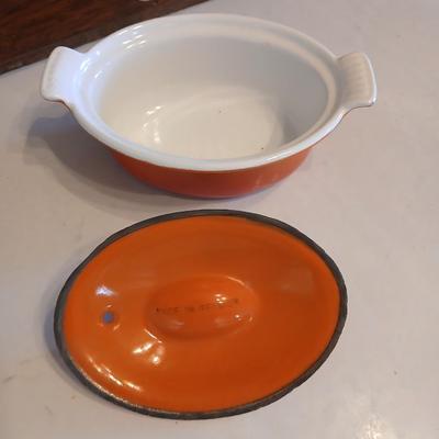 Vintage Le Creuset heritage-style Decoware mini dutch oven or casserole dish in the signature Flame Orange color.