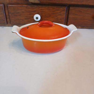 Vintage Le Creuset heritage-style Decoware mini dutch oven or casserole dish in the signature Flame Orange color.