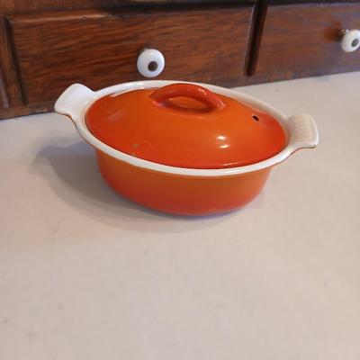 Vintage Le Creuset heritage-style Decoware mini dutch oven or casserole dish in the signature Flame Orange color.