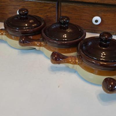 ceramic French onion soup bowls / lidded crocks, and a matching double salt and pepper shaker set.