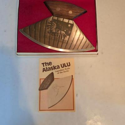 Wooden cutting board with 5 Pampered Chef Quickut Paring Knives and an Alaskan Ulu knife