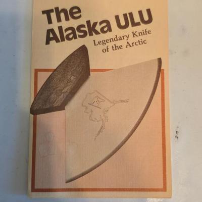 Wooden cutting board with 5 Pampered Chef Quickut Paring Knives and an Alaskan Ulu knife