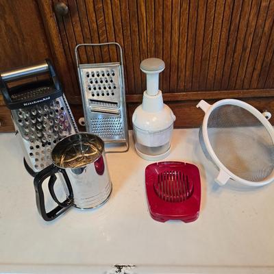 Kitchen gadgets - cutters, slicers and dicers with a strainer and a chrome flour sifter