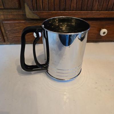 Kitchen gadgets - cutters, slicers and dicers with a strainer and a chrome flour sifter