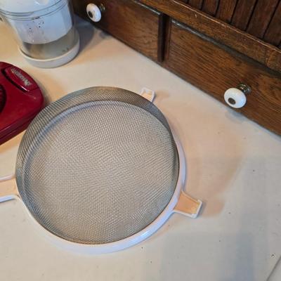 Kitchen gadgets - cutters, slicers and dicers with a strainer and a chrome flour sifter