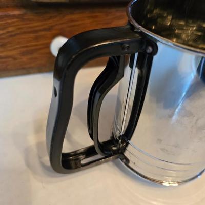 Kitchen gadgets - cutters, slicers and dicers with a strainer and a chrome flour sifter