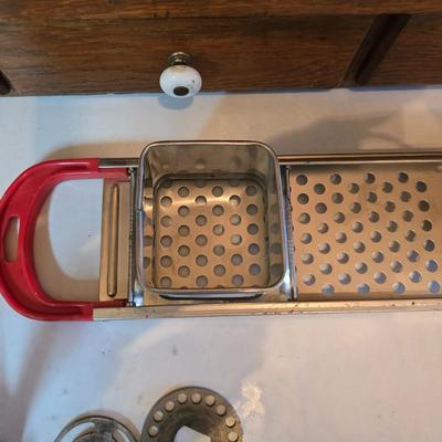 Kitchen gadgets = stainless steel spaetzle maker -Climax manual food and meat chopper and a vintage metal, box-style cheese grater