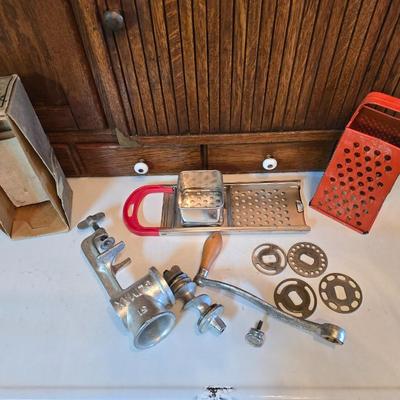 Kitchen gadgets = stainless steel spaetzle maker -Climax manual food and meat chopper and a vintage metal, box-style cheese grater