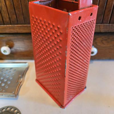 Kitchen gadgets = stainless steel spaetzle maker -Climax manual food and meat chopper and a vintage metal, box-style cheese grater
