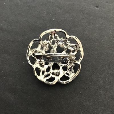 Silvertone brooch with light, purple rhinestones