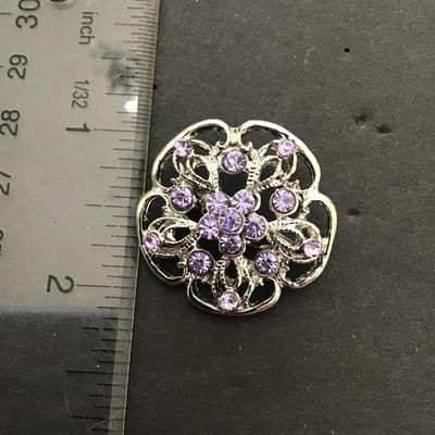 Silvertone brooch with light, purple rhinestones