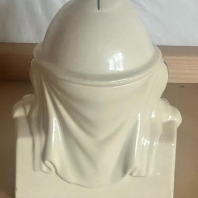 Sale Photo Thumbnail #2: Charming vintage Humpty Dumpty cookie jar, featuring the classic nursery rhyme character sitting on a brick wall. Hand-painted ceramic with soft pastel tones, green bowtie, and striped outfit. Two-piece design with removable head lid.
Perfect for vintage 