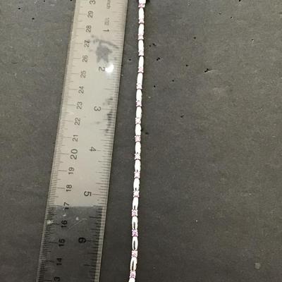 Silver tone, tennis bracelet with lavender rhinestones