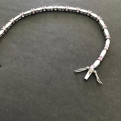 Silver tone, tennis bracelet with lavender rhinestones