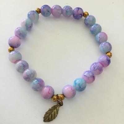 Beautiful cotton candy, color glass bead stretch bracelet gold on it