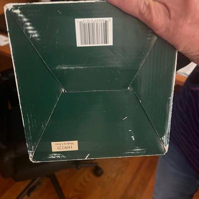 Sale Photo Thumbnail #14: Charming Geppeddo porcelain doll with blonde curls, lace-trimmed dress in rose pink, and small teddy bear accessory. Comes in original green display box with viewing window. Doll appears to have never been removed from box.
Box shows some creasing and sto