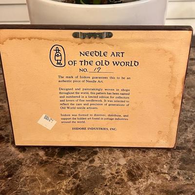 Sale Photo Thumbnail #16: Limited-edition Isidore Industries “Needle Art of the Old World” No. 19, featuring a woven cottage scene and the quote:
“A house is like a pair of shoes… it grows more comfortable with age.”
Authentic hand-woven piece mounted under glass in its 