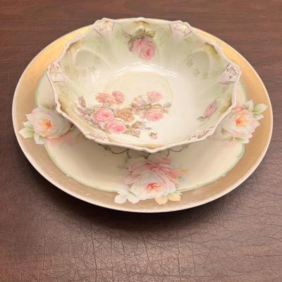 Sale Photo Thumbnail #30: Lovely pair of antique Prussian porcelain dishes, featuring hand-painted roses and elegant gold embellishment. The set includes:
1️⃣ RS Prussia shallow bowl – soft green fade, pink rose clusters, ornate scalloped rim, gold details.
2️⃣ C.J. Prus