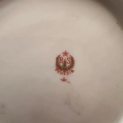 Sale Photo Thumbnail #31: Lovely pair of antique Prussian porcelain dishes, featuring hand-painted roses and elegant gold embellishment. The set includes:
1️⃣ RS Prussia shallow bowl – soft green fade, pink rose clusters, ornate scalloped rim, gold details.
2️⃣ C.J. Prus