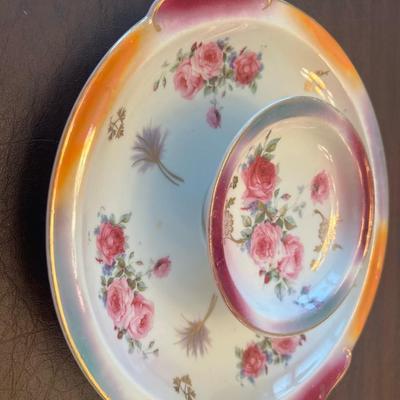 Sale Photo Thumbnail #55: Charming pair of early 20th-century German porcelain serving plates featuring hand-painted florals and grapevine motifs with gold trim.
Includes:
1️⃣ Porcelain handled tray with purple grape cluster design – marked “Jäger & Co Bavaria Germany,”