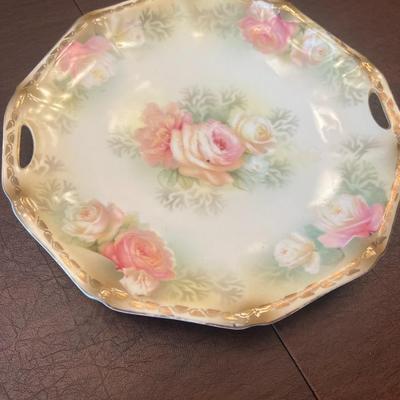 Sale Photo Thumbnail #64: Beautiful trio of early 20th-century European porcelain display plates, each showcasing hand-painted or transfer-decorated artistry and fine embossed detailing.
Included:
1.	Game Bird Plate – embossed rim with scalloped edges, featuring a detailed pheas