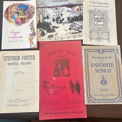 Sale Photo Thumbnail #78: Assorted collection of vintage and mid-century softcover songbooks featuring classic Christmas carols, parlor songs, and Americana standards. A nostalgic lot perfect for pianists, collectors, or seasonal décor.
Includes:
1.	Carols of Christmas – Music 