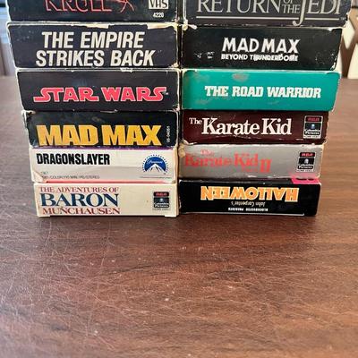 Sale Photo Thumbnail #85: Classic vintage VHS lot featuring 1980s sci-fi, fantasy, and action blockbusters. Includes Star Wars, The Empire Strikes Back, Return of the Jedi, Krull, Dragonslayer, The Adventures of Baron Munchausen, Mad Max, The Road Warrior, Mad Max Beyond Thunderdo