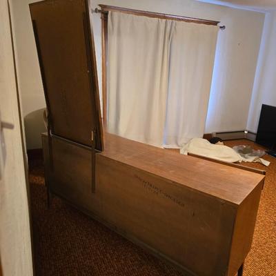 Mid-century modern walnut nine-drawer lowboy dresser by Dixie Furniture Co. with a matching mirror.