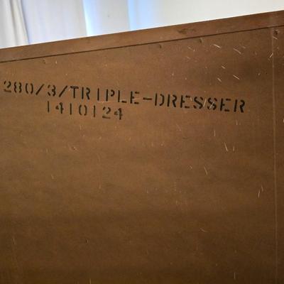 Mid-century modern walnut nine-drawer lowboy dresser by Dixie Furniture Co. with a matching mirror.