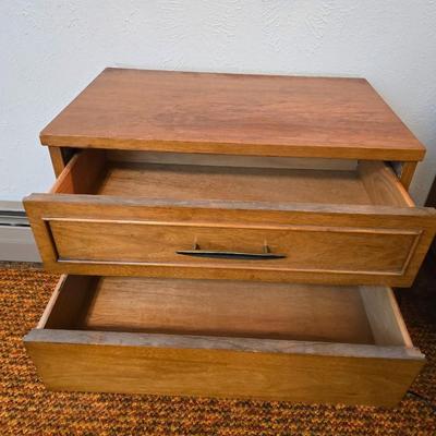 Mid-century modern walnut nightstand or side table by Dixie Furniture Co. with brass lamp and an alarm clock