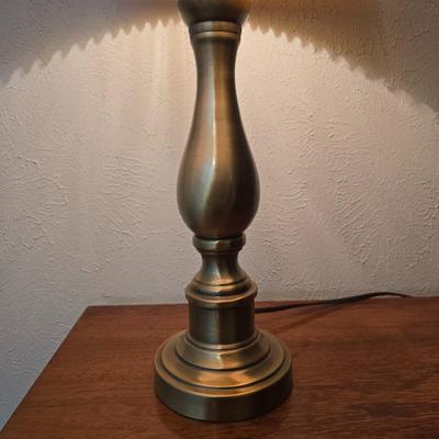 Mid-century modern walnut nightstand or side table by Dixie Furniture Co. with brass lamp and an alarm clock