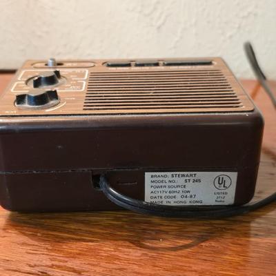 Mid-century modern walnut nightstand or side table by Dixie Furniture Co. with brass lamp and an alarm clock