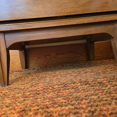 Mid-century modern walnut nightstand or side table by Dixie Furniture Co. with brass lamp and an alarm clock