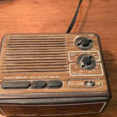 Mid-century modern walnut nightstand or side table by Dixie Furniture Co. with brass lamp and an alarm clock