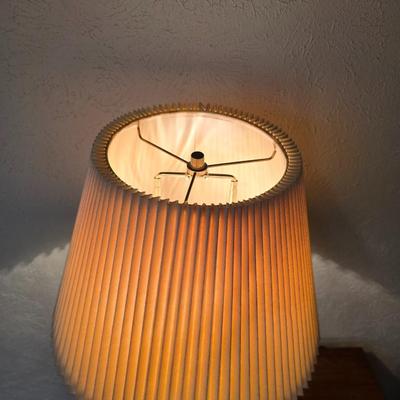 Mid-century modern walnut nightstand or side table by Dixie Furniture Co. with brass lamp and an alarm clock