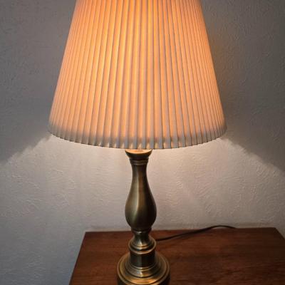 Mid-century modern walnut nightstand or side table by Dixie Furniture Co. with brass lamp and an alarm clock