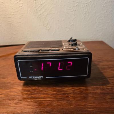 Mid-century modern walnut nightstand or side table by Dixie Furniture Co. with brass lamp and an alarm clock