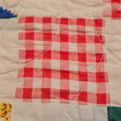 Handmade patchwork quilt featuring a scrappy nine-patch block design and a light purple border. Postage Stamp quilt Irish Chain pattern