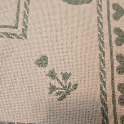 handmade green and white crochet blanket with a leaves pattern and fringed edges with a knitted reverse cat themed throw