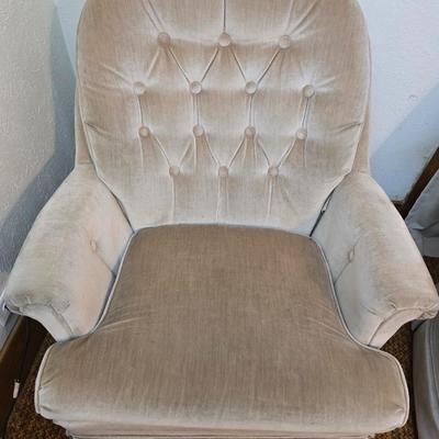 Pair of Best Chairs Inc. upholstered swivel rocker chairs with tufted backs and skirted bases.