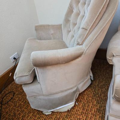 Pair of Best Chairs Inc. upholstered swivel rocker chairs with tufted backs and skirted bases.