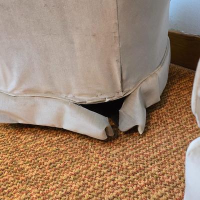 Pair of Best Chairs Inc. upholstered swivel rocker chairs with tufted backs and skirted bases.