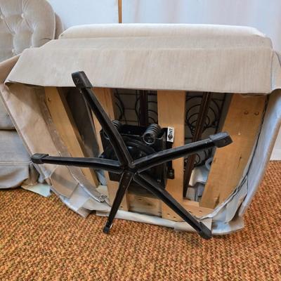 Pair of Best Chairs Inc. upholstered swivel rocker chairs with tufted backs and skirted bases.