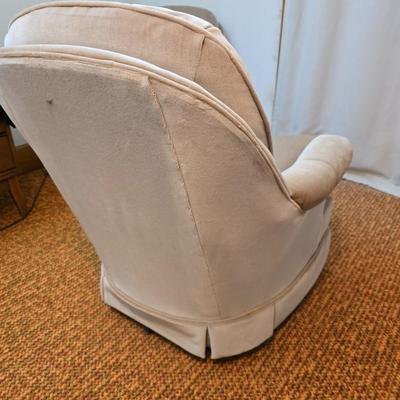 Pair of Best Chairs Inc. upholstered swivel rocker chairs with tufted backs and skirted bases.