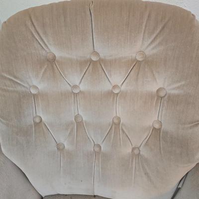 Pair of Best Chairs Inc. upholstered swivel rocker chairs with tufted backs and skirted bases.