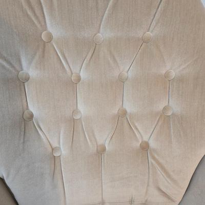 Pair of Best Chairs Inc. upholstered swivel rocker chairs with tufted backs and skirted bases.