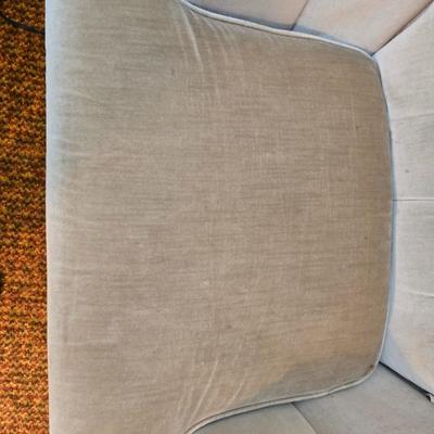 Pair of Best Chairs Inc. upholstered swivel rocker chairs with tufted backs and skirted bases.