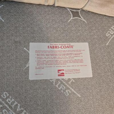 Pair of Best Chairs Inc. upholstered swivel rocker chairs with tufted backs and skirted bases.