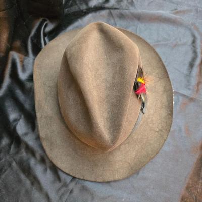 Bronzine felt Stetson Sutley fedora hat with a black grosgrain ribbon and feather accent. Size 7 1/4